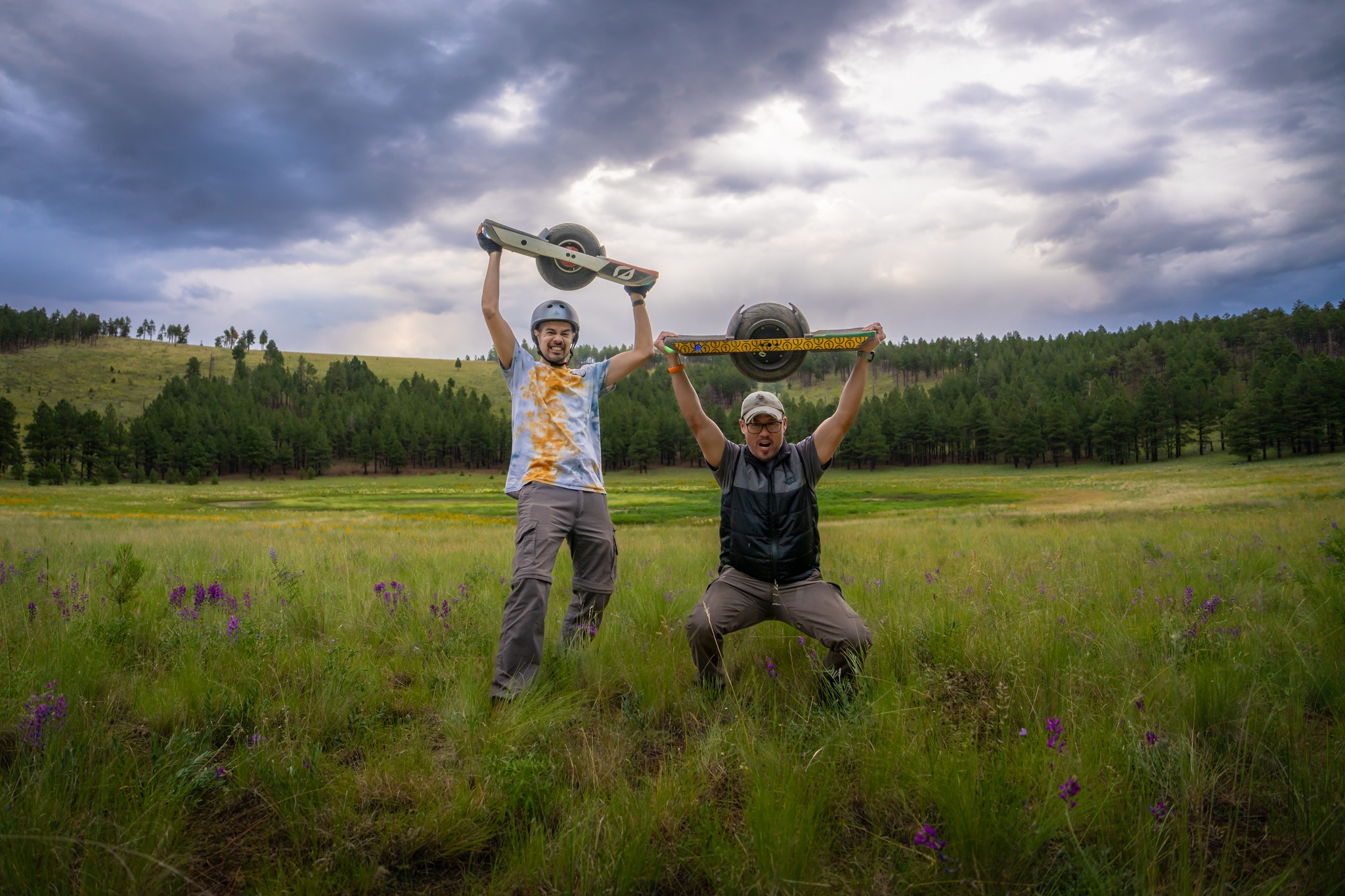Steve Ginter and friend holding Onewheels above their heads